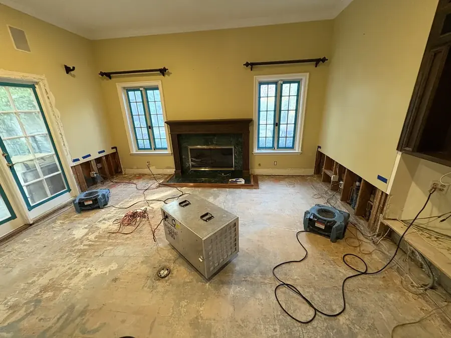 Air movers and a dehumidifier drying a room in Derry, NH