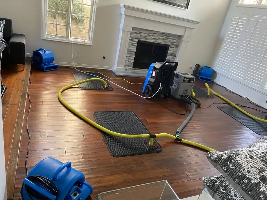 Air movers and dehumidifiers drying a Derry, NH room